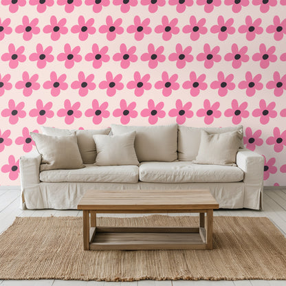 Blue velvet sofa positioned against the wallpaper to show contrast between saturated upholstery and soft blush ground