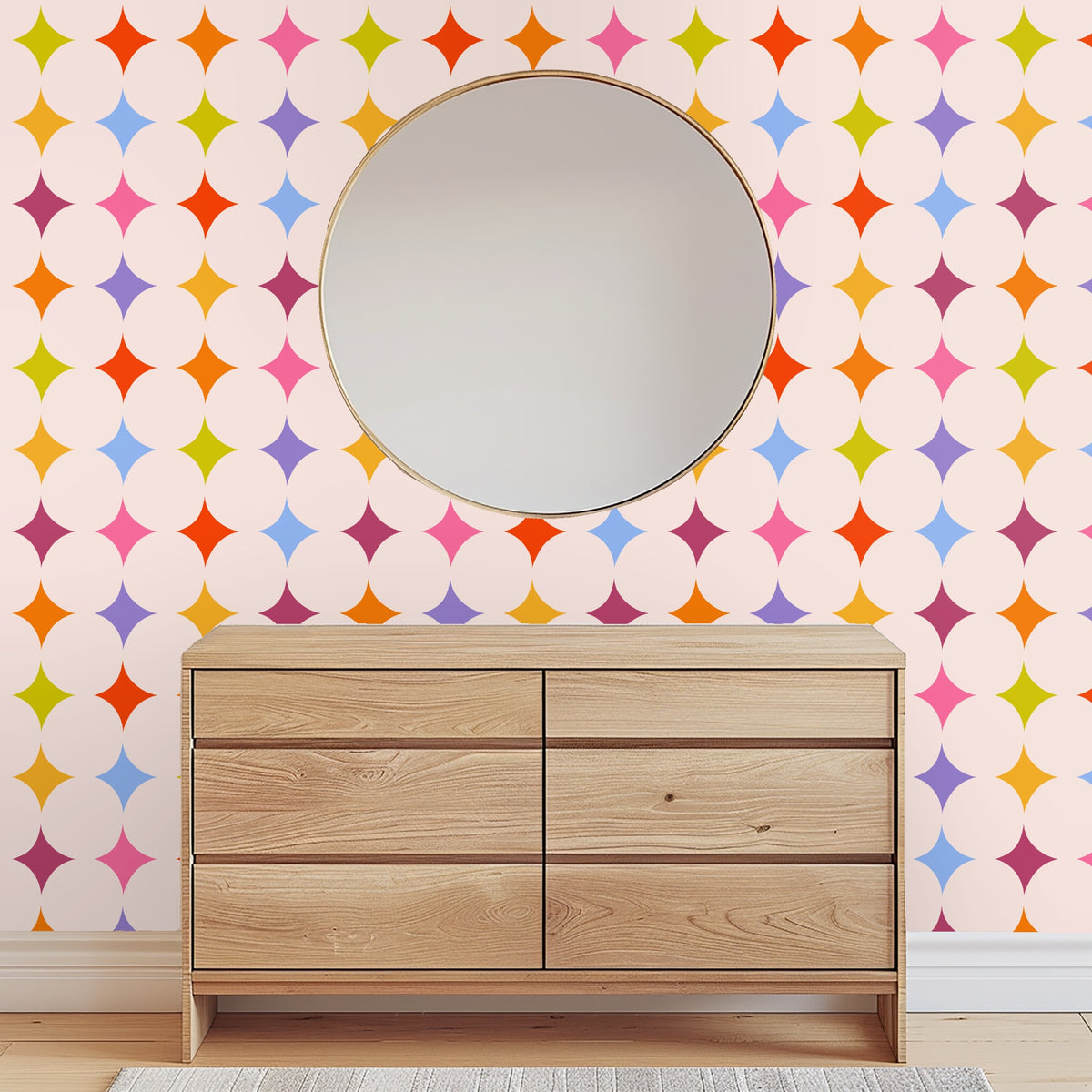 Close-up of Jubilee Starfield wallpaper showing lozenge-shaped stars in orange, lime, pink, blue and purple on a soft blush background