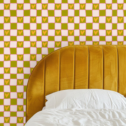 Living room wall covered in Heartfield Check wallpaper behind an orange sofa and layered rug