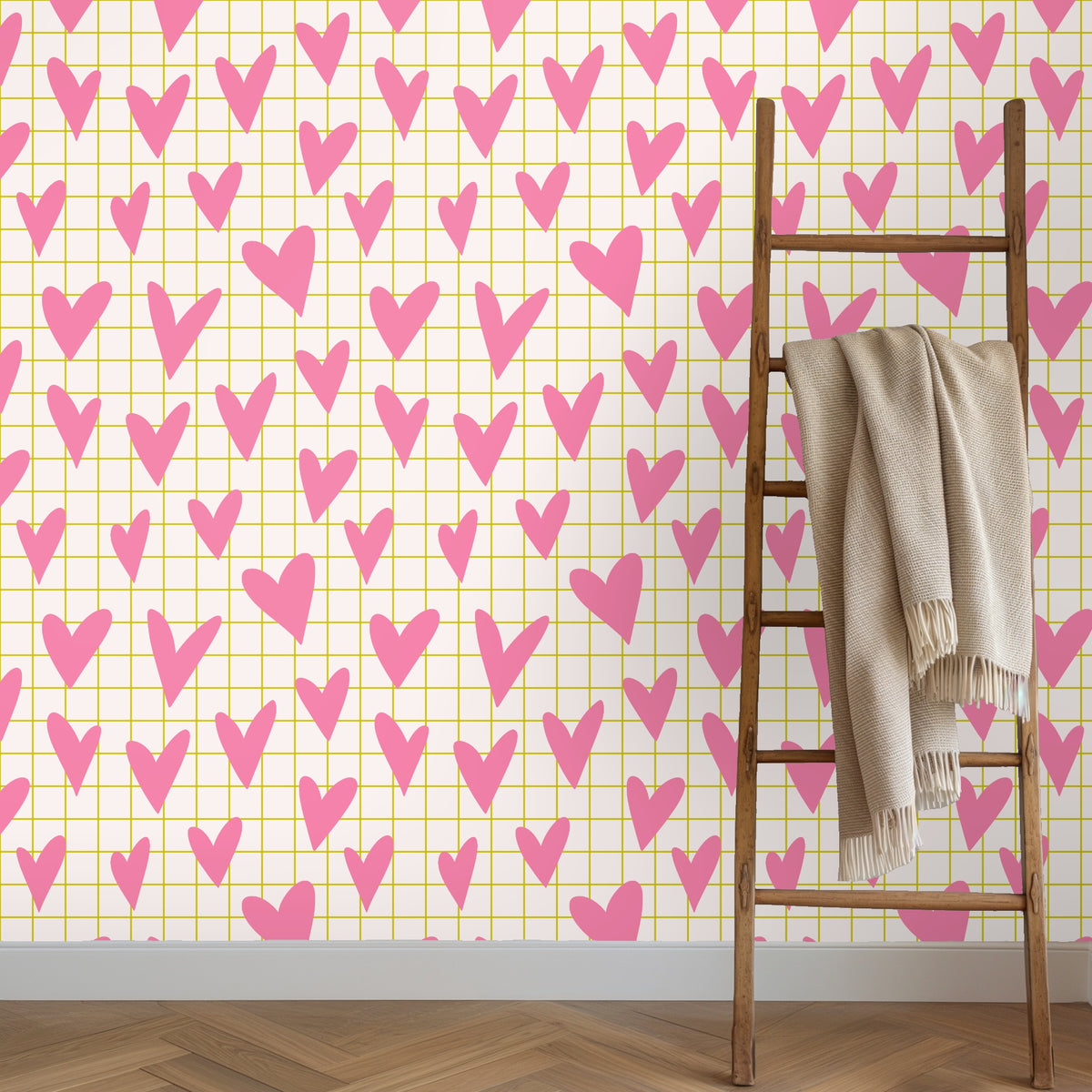Styled vignette of wallpaper with a candle and small glass vase, highlighting the pattern at tabletop height.