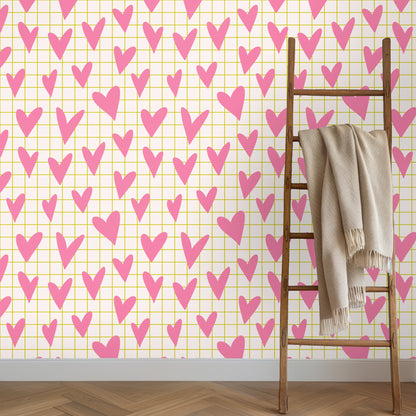 Styled vignette of wallpaper with a candle and small glass vase, highlighting the pattern at tabletop height.