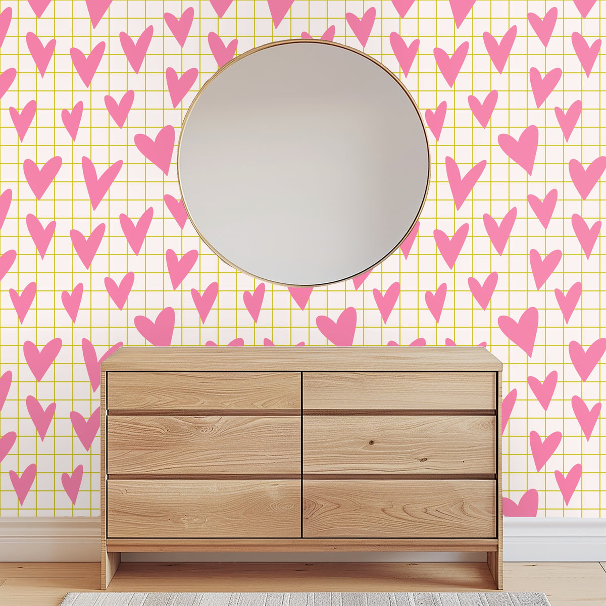Close-up of pattern artwork showing bubblegum pink hand-drawn hearts over a pale cream background with a thin mustard grid.
