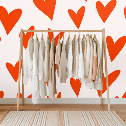 Bathroom medicine cabinet open against a wall covered in large orange heart pattern.