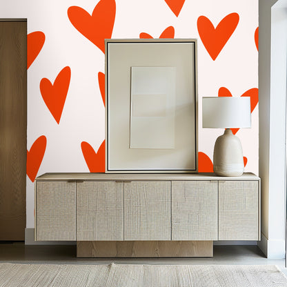 Close view of heart motif behind a wooden shelf with red ceramic bowls.
