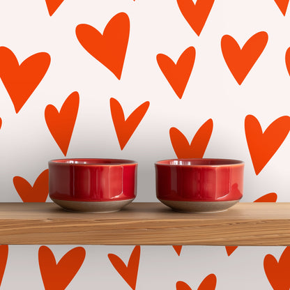 Living room scene with mid-century seating and an oversized heart wallpaper mural.