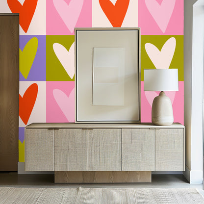 Blue velvet sofa positioned in front of the colorful heart checkerboard wallpaper for a dramatic contrast.