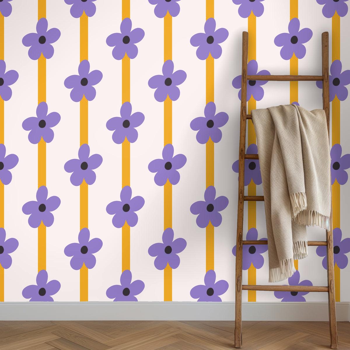 Midshot of wallpaper behind a deep blue velvet sofa, showing scale of lilac flowers and vertical mustard columns