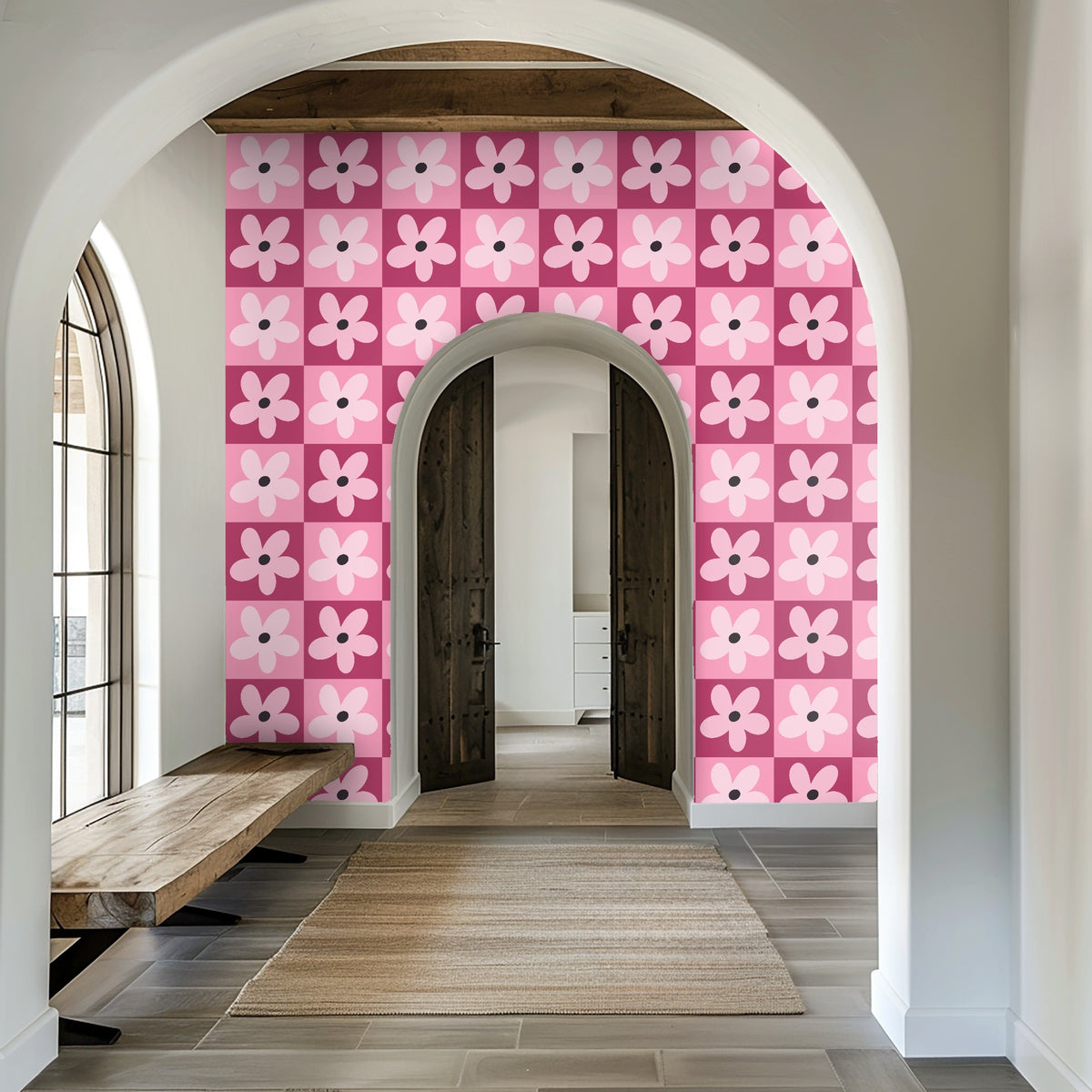 Entryway archway framing a wall covered in the pink checkerboard daisy wallpaper.