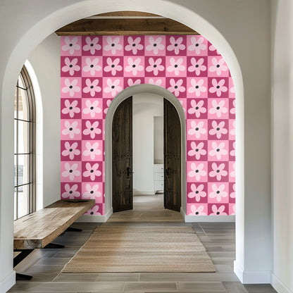 Entryway archway framing a wall covered in the pink checkerboard daisy wallpaper.