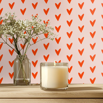 Close crop of the Coral Heart Study pattern: red‑orange, hand-drawn hearts on a pale blush background.