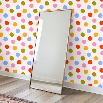 Nursery scene with crib placed in front of Palm Dot Parade wallpaper, colorful dots creating a playful backdrop