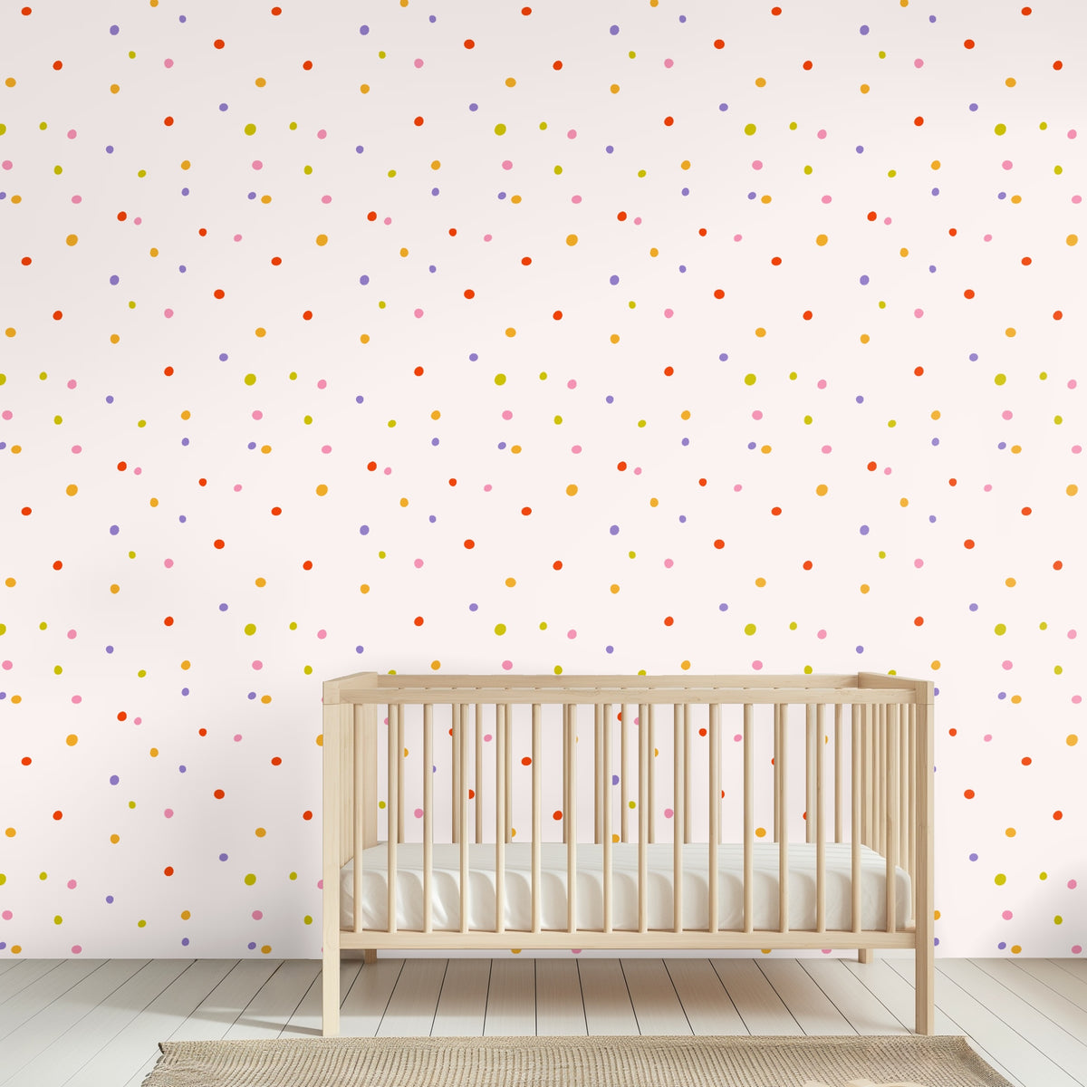 Full repeat view of Sweet Spot Polka pattern: irregular multicolor dots on a pale blush background.
