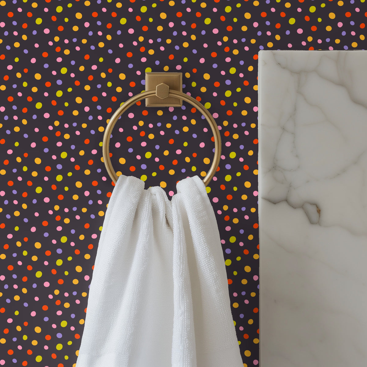 Bathroom close-up: towel ring and marble edge with wallpaper of small multicolor dots on dark background