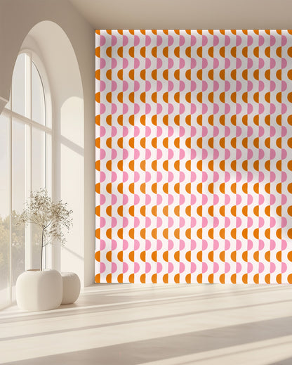 Kitchen styling shot with the semicircle wallpaper as a backdrop to a wooden shelf holding lemons and a cake.