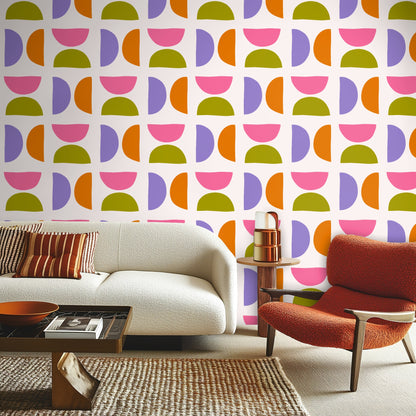 Large sample of Half & Harmony wallpaper showing repeated semicircles in pink, lavender, orange and olive on a soft off‑white background.