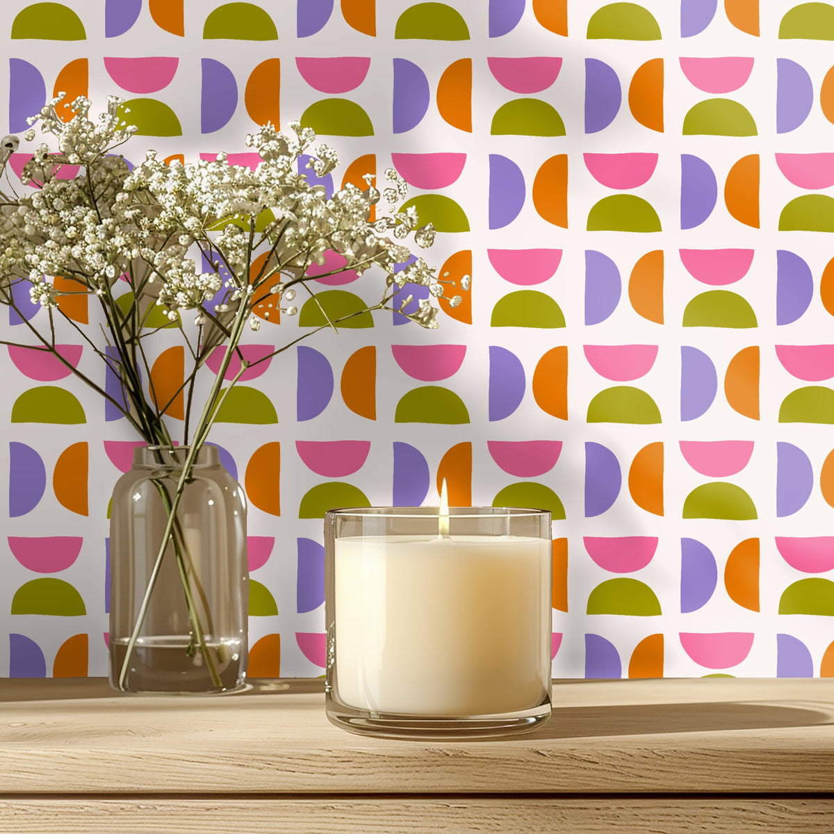 Close-up vignette of the wallpaper behind a lit candle and glass bud vase, highlighting the small-scale repeat and color contrast.
