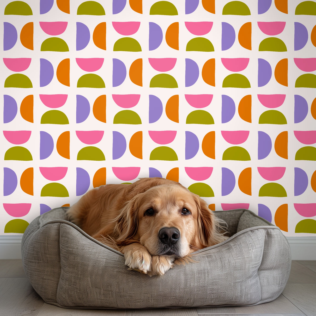 Living room installation with sofa and accent chair against the wallpaper, illustrating how the repeat reads at full-room scale.