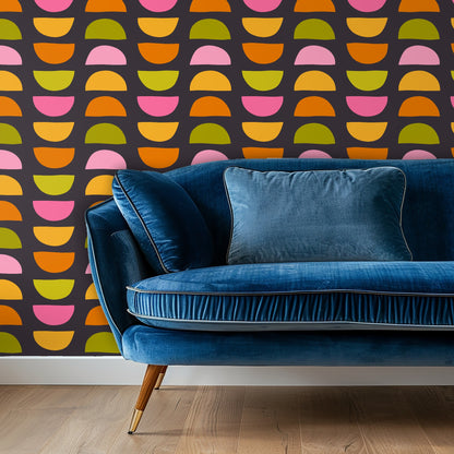 Entry vignette with console and framed art against the bold charcoal wallpaper patterned with colorful half-moons.
