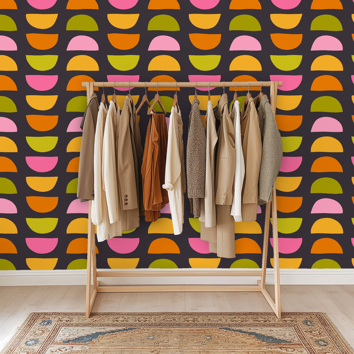 Close crop of wallpaper in a bathroom setting with a brass towel ring and marble sink edge visible beside the pattern.