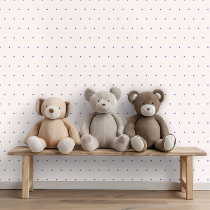 Close-up of pattern showing pale blush background with evenly spaced lilac polka dots