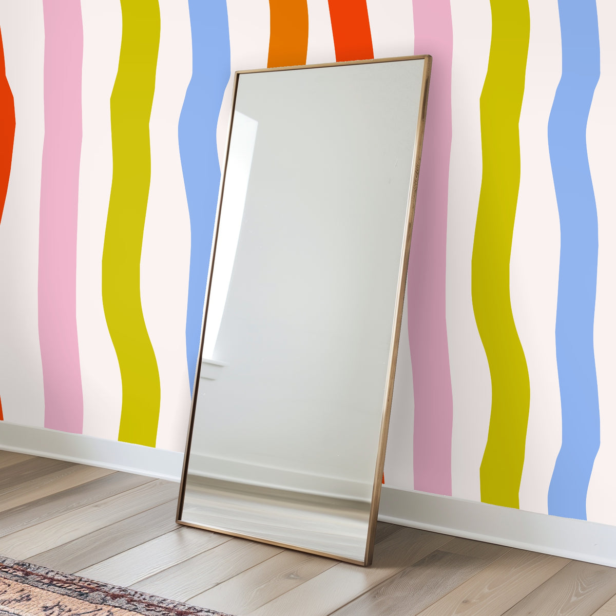 Cropped wall vignette of the large-scale wavy stripes behind a sofa, demonstrating pattern scale and color contrast with neutral furnishings