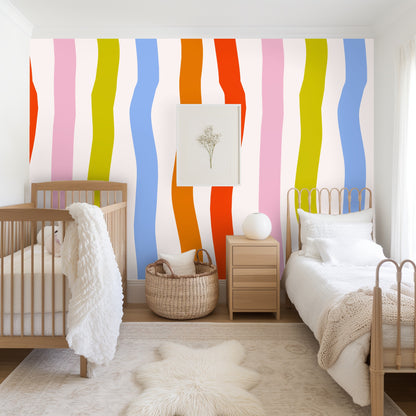 Pattern view behind a floor mirror, showing the repeat and bold color rhythm of coral, orange, blue, chartreuse and pink ribbons
