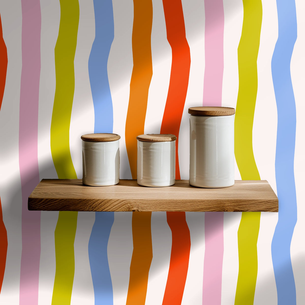 Close-up of the Calypso Ribbons pattern showing wide wavy vertical stripes in coral, orange, periwinkle blue, chartreuse and soft pink on a-