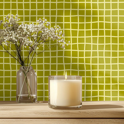 Tabletop vignette with lit candle and delicate flowers placed before the Vireo Lattice pattern.