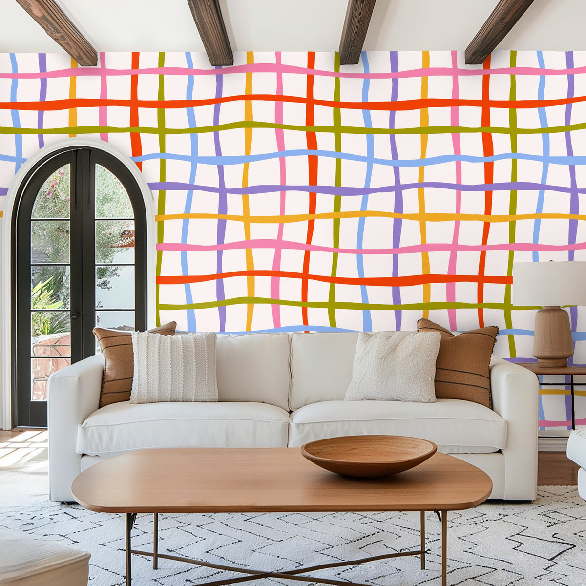 Arched entryway niche with round mirror showing Ribbon Lattice wallpaper used as a colorful focal backdrop