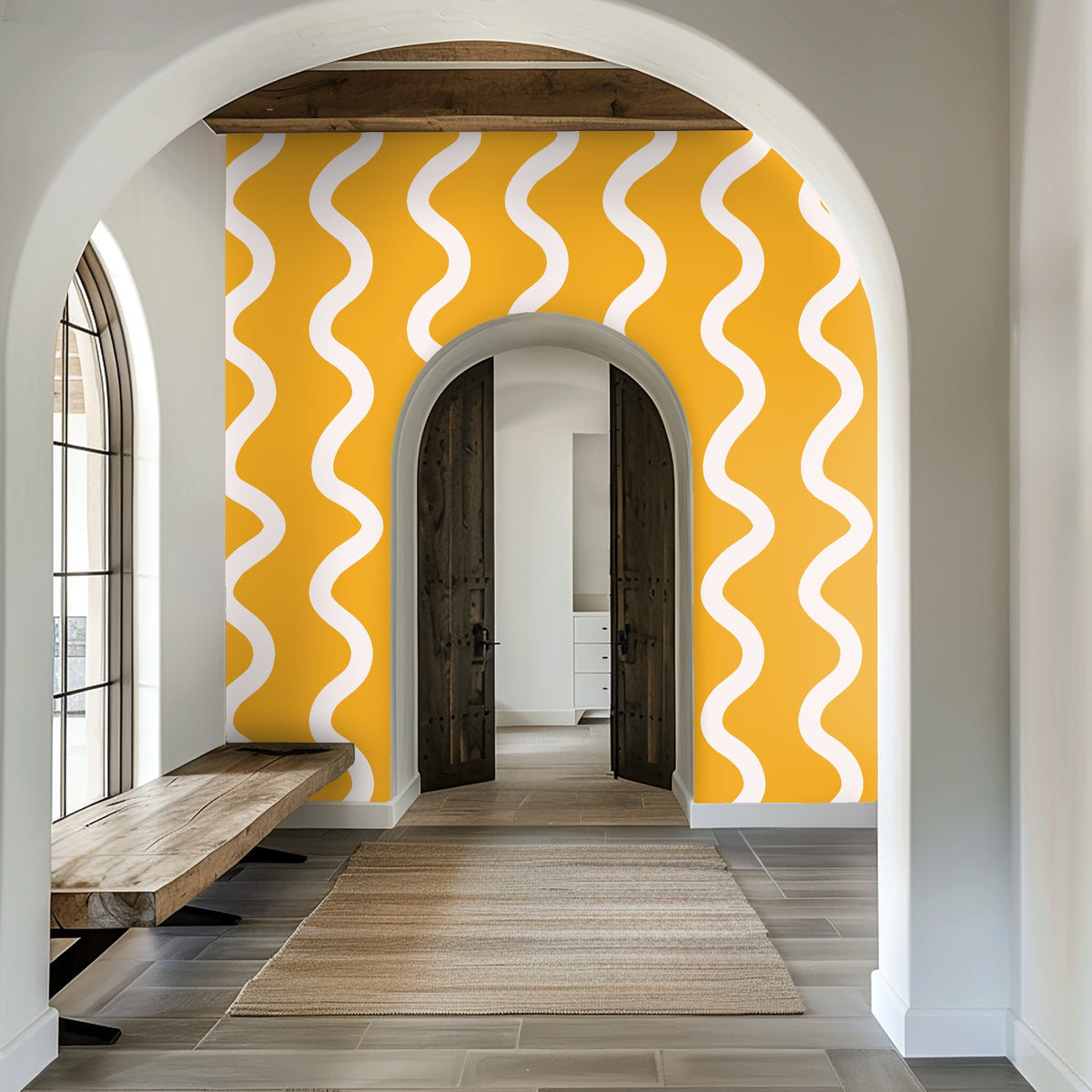 Arched entryway with a full-height saffron wave wallpaper creating a bright, graphic focal wall
