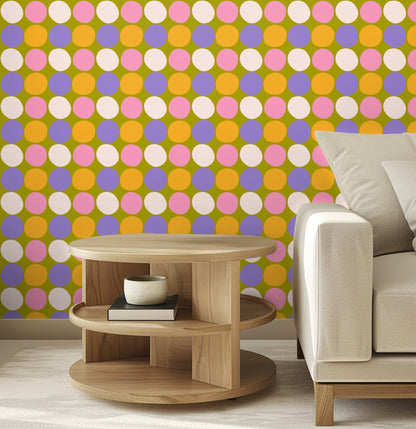 Close crop showing the medium-scale dot repeat and how the colors interact against the olive ground next to a side table