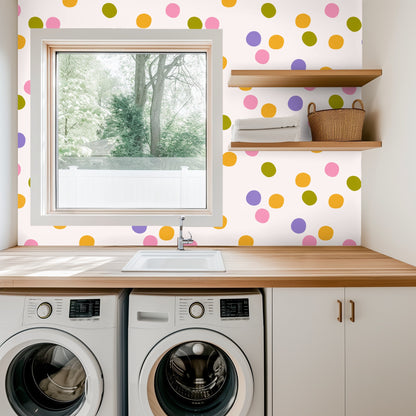 Decor vignette with Confetti Sonata wallpaper, a lit candle and delicate white flowers on a wooden surface