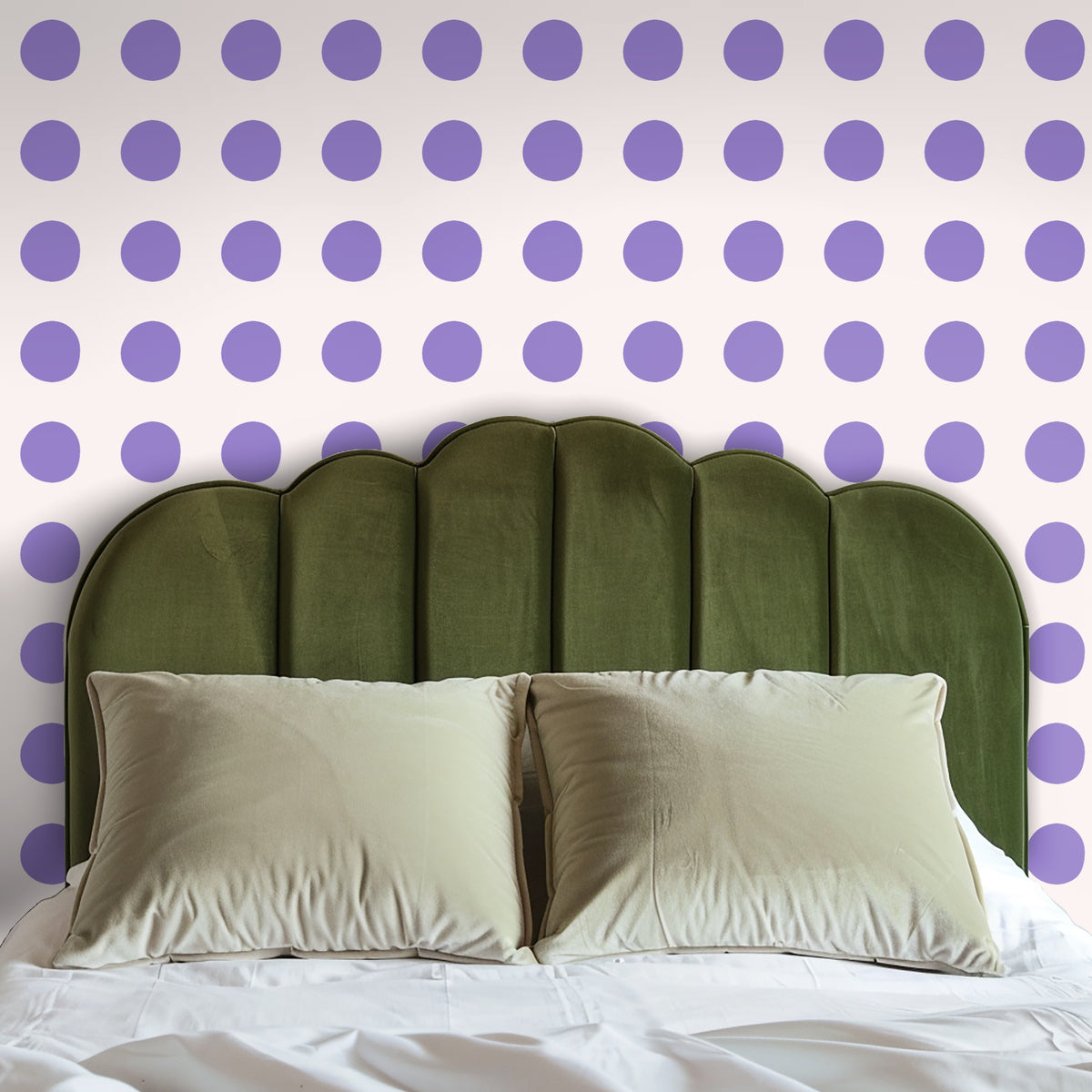 Living room with neutral sofa in front of a wall covered in large lilac polka dot wallpaper