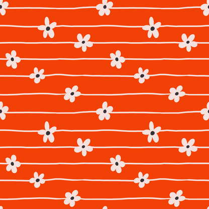 Detail shot: irregular hand-drawn stripes and five-petal flowers with pale petals and dark centers on vivid clementine background.