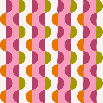 Portrait-style shot of a person posed in front of Blossom Arc Stripe wallpaper to show human scale and how the pattern reads at eye level