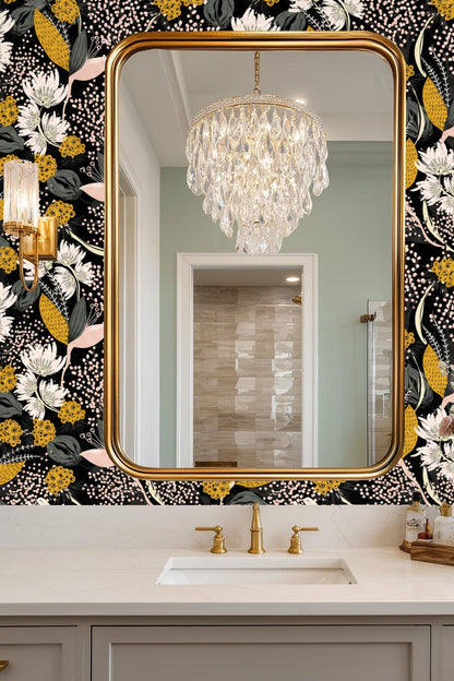 Side view of mustard-yellow flower buds and delicate pink petals on wallpaper.