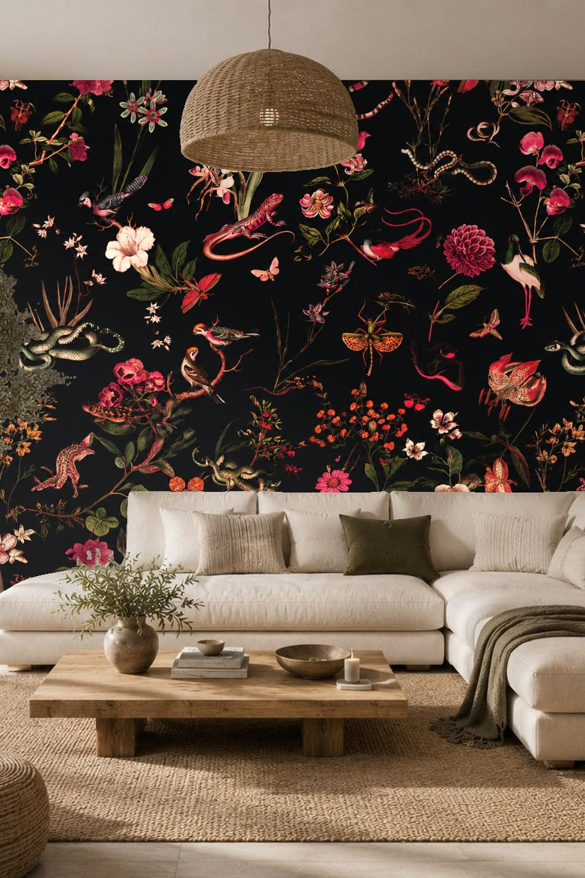 Living room wall adorned with floral and fauna wallpaper in rich reds and greens on black